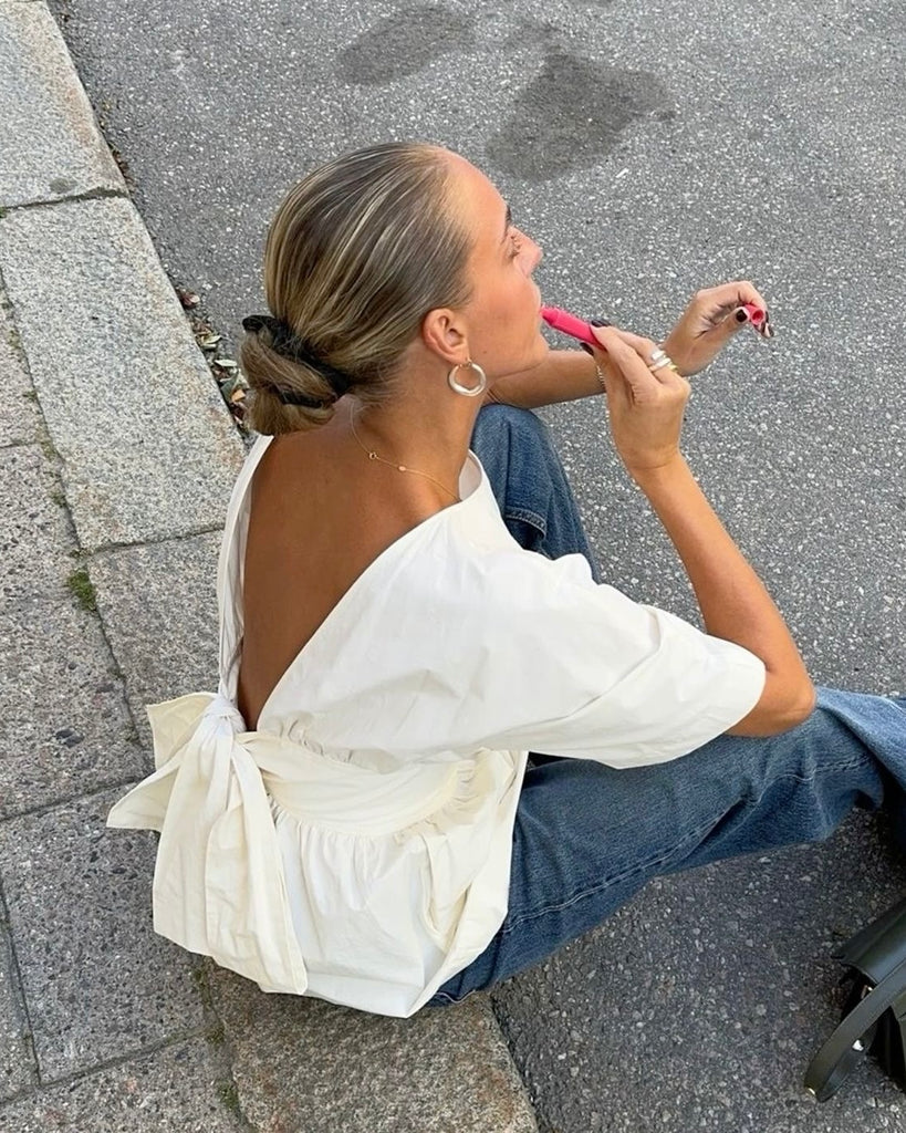 Witte peplum blouse met open rug en strik detail