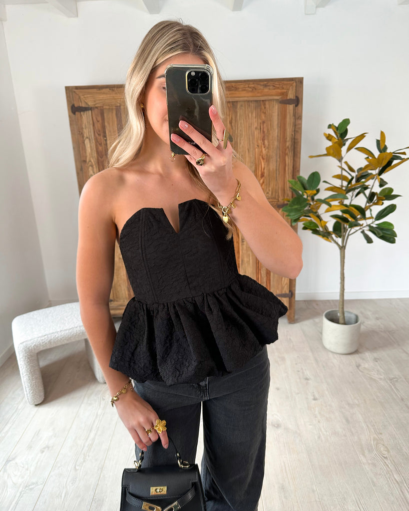 Zwarte strapless peplum top met hartvormige decolleté en gestructureerd patroon