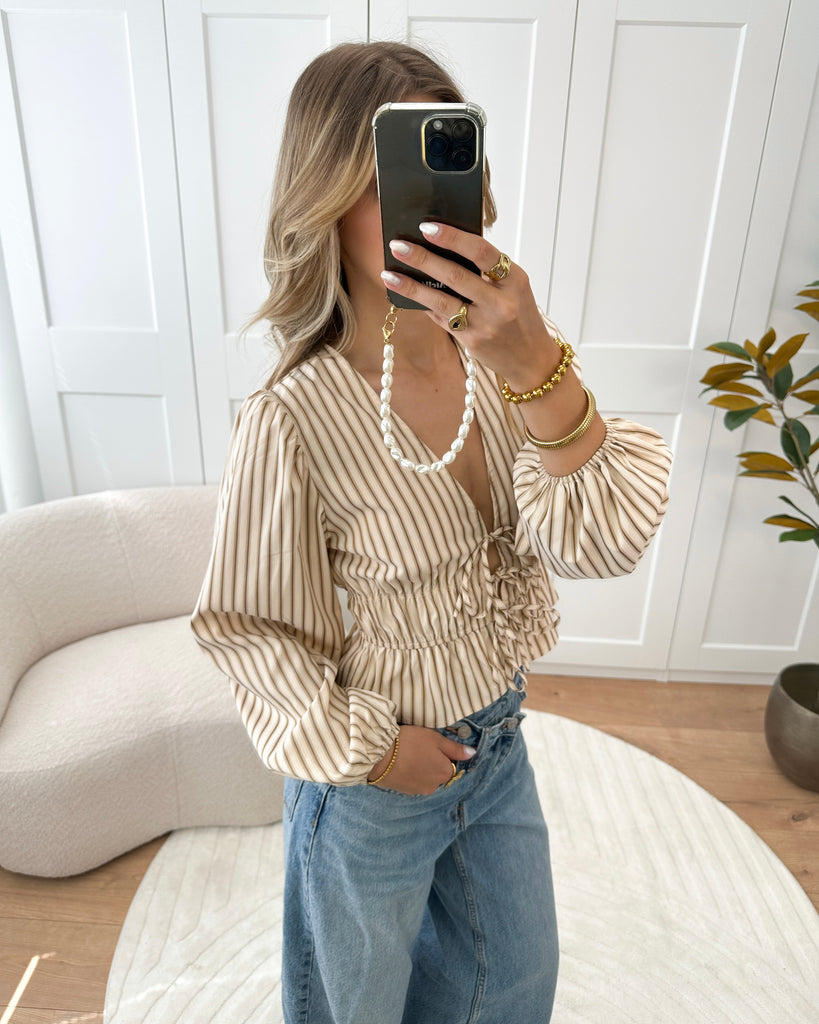 Beige peplum blouse met bruine strepen en strikjes